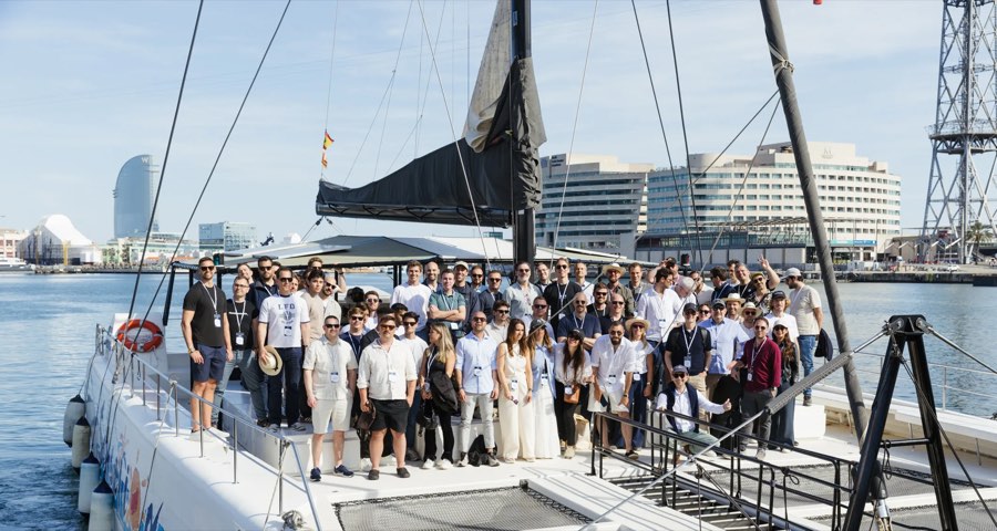 A large group of founders on a catamaran in Barcelona harbor